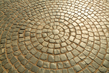 The pavement is paved with stones in the shape of a circle