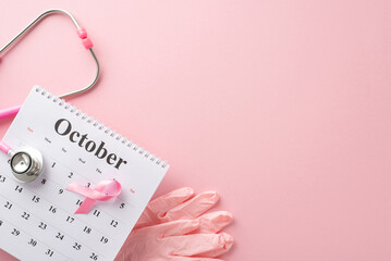Breast cancer screening reminder. Overhead shot of pink surgical gloves, stethoscope, and October...