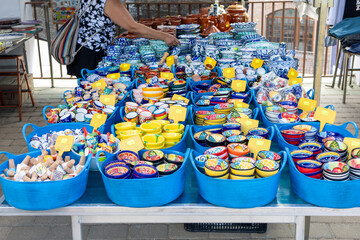 Vibrant ceramic pieces at the lively market, showcasing artisanal craftsmanship and unique designs