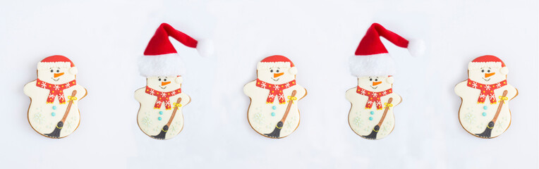 Christmas gingerbread in the shape of a snowman with Santa Claus hat on the white background. Flat...