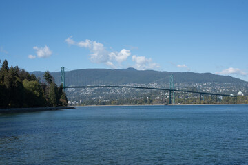 bridge over the ocean with mountain views