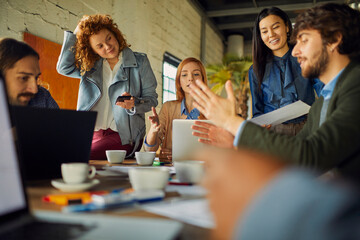 Young and diverse group of designers having a meeting in an office while working in a startup company