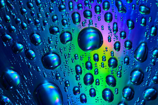 Water Drops Flowing Across Silvery Blue And Green Abstract Background Asset