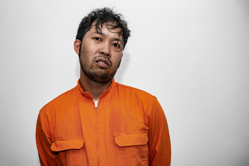 Prisoner in orange robe concept,Portrait of asian handsome man in Prison uniforms,Bandit has a lot...