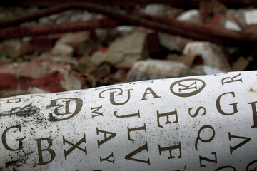 old mattress with arbitrary letters written on it placed on a garbage pile
