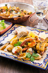 Traditional Portuguese seafood cataplana with king prawns, vongole clam and fiesh in white wine...