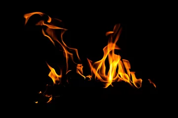 Fotobehang Brandhout textuur Fire flame texture. Burning material backdrop. Burn effect pattern. Blaze and torch wallpaper. Heat and haze backdrop.