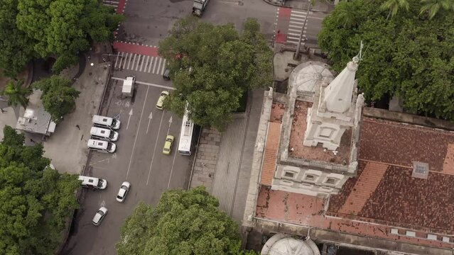 Overhead aerial view of church and cars riding on road at Largo do Machado Square in Rio de Janeiro, Brazil