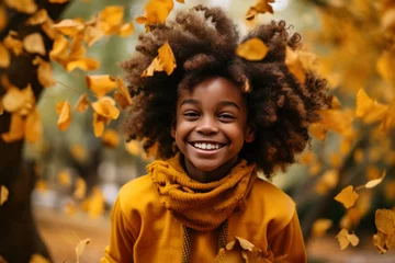  African american girl with afro hairstyle smiling and walking in autumn park. © Anna