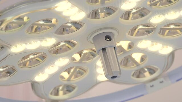 The surgical lamp shines bright. Action. View from the operating table, operating room details at a hospital.