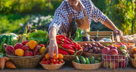 The farmer sells fruits and vegetables at the farmers market. Selective focus.