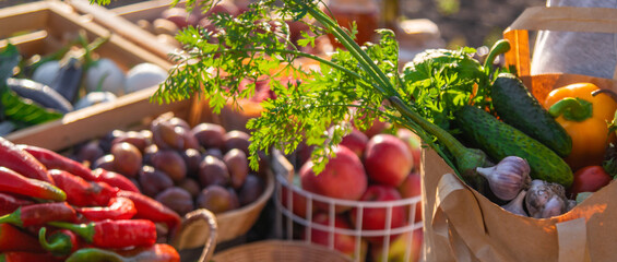 A woman buys fruits and vegetables at a farmers market. Selective focus.