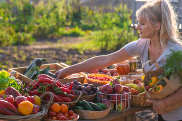 A woman buys fruits and vegetables at a farmers market. Selective focus.