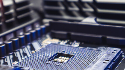 AM4 CPU Socket on motherboard of modern powerful PC. Desktop computer hardware chipset components close-up in blue light. Tech industry electronics background