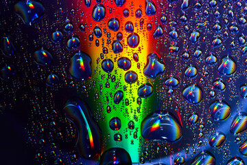 Upward rainbow colored beam of light through fizzy bubbles in underwater abstract background asset