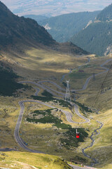 Red cable car to Balea Lake over the famous mountain Transfagarasan Road, Carpathian Moutains, Romania. Vertical frame