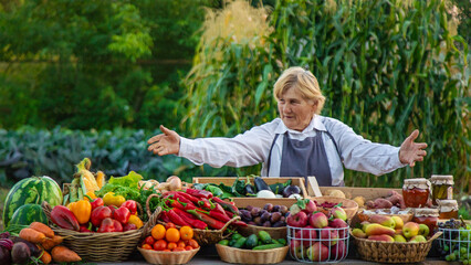 old woman farmer sells vegetables and fruits at the farmers market. Selective focus.