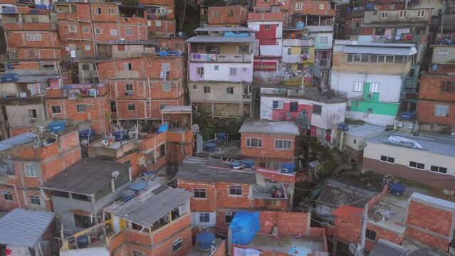 Close-up aerial tracking past colourful favela houses in Rio de Janeiro, Brazil