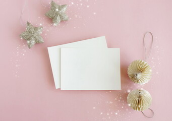 Christmas card mockup with copy space, xmas decor top view flatlay on pink background. Greeting...