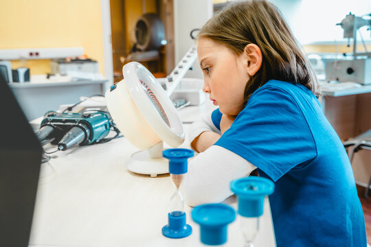 Little girl in medical office undergoing advanced laser vision treatment, correction for eyes health. Pediatric ophthalmology procedure. Visual acuity, strabismus improvement. Advanced technology