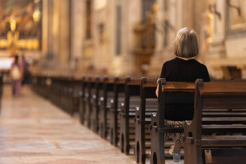 A woman sits in a church