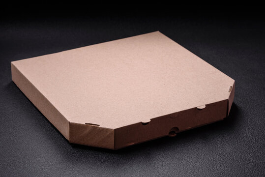Empty cardboard rectangular brown box for delivery of delicious pizza