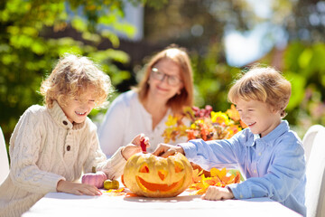 Family carving pumpkin for Halloween