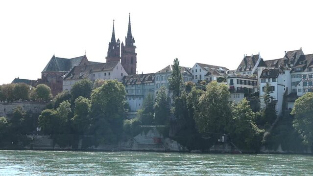 Basler Muenster with the Rhein at summer, The Rhine River flowing past some historical buildings in Basel, Switzerland.