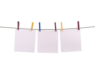 tThree blank notes hanging on the string with clothespins