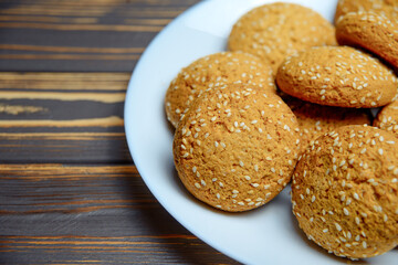 Oatmeal cookies for breakfast. Cookies in a bowl. Wooden old background