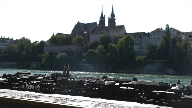 BASEL, SWITZERLAND - 09. SEPTEMBER 2023: Bronze miniature of Basel on the Basler Muenster background. 4K, 50 fps