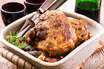 Traditional barbecued Greek lamb shoulder with with eggplant and tomato cheese sauce served as...