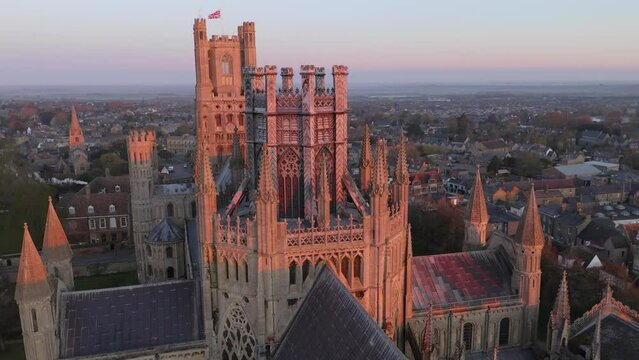 Aerial reveal view Cathedral of Ely city in Cambridgeshire, England, UK. Famous travel destination and anglican churches .Traditional countryside house architecture background