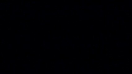 Person putting out the lit candle isolated in the black empty background