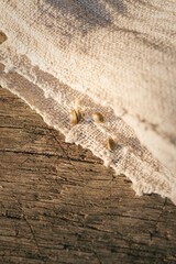 Linen cloth on the ground with cannabis seeds in sunlight