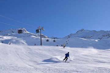 Downhill skiers in Hochgurgl ski resort on a beautiful sunny day, perfect conditions for winter...