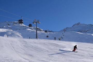 Downhill skiers in Hochgurgl ski resort on a beautiful sunny day, perfect conditions for winter...