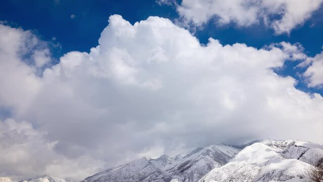 Time lapse of clouds over the snow covered Wasatch Mountains near Salt Lake City, Utah.