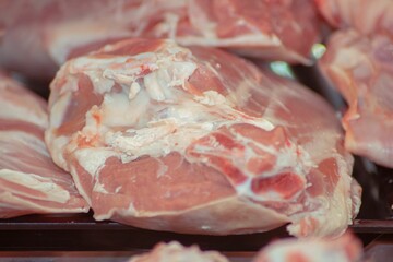 Raw cuts of meat, laid out on a black surface