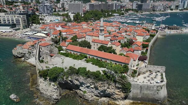 Aerial video of Budva Old Town and mountains on the sea shore, Montenegro