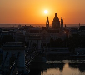 Breathtaking view of the Chain Bridge in Budapest, Hungary, illuminated by the rising sun