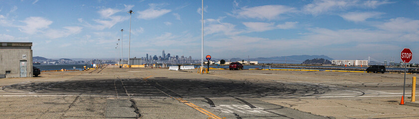Sideshow activity tire marks on pier in Alameda California with San Francisco in background
