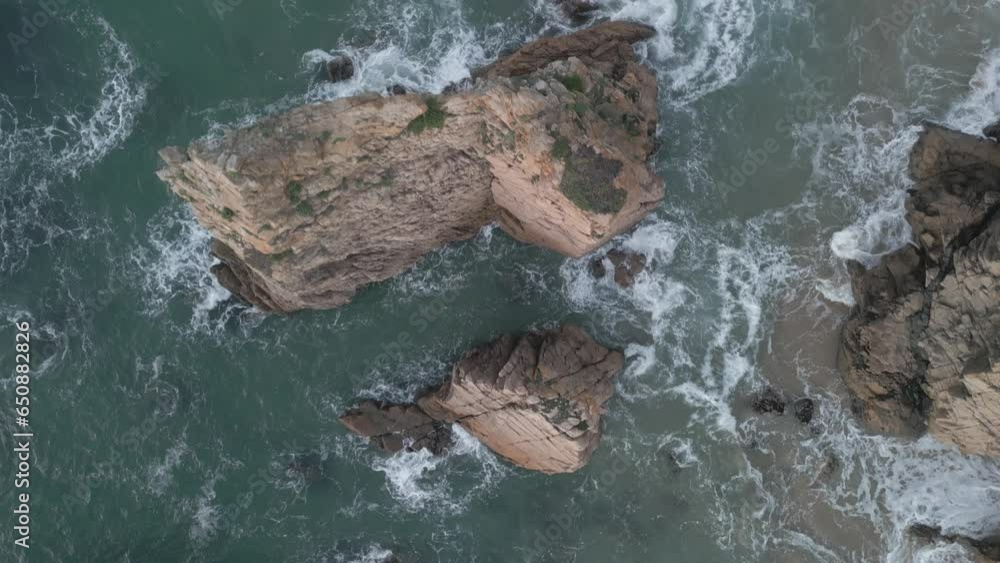 Canvas Prints Aerial footage of Praia Da Ursa Beach In Sintra Portugal with splashing sea waves