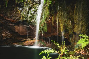 Stunning waterfall cascading down the rocky mountainside into a tranquil pool