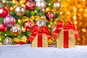 boxes with gifts and bows on the background of a Christmas tree