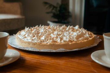 Appetizing dessert of a delicious lemon pie on a wooden table