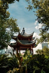 Ornate Asian-style building surrounded by lush trees in downtown Orlando
