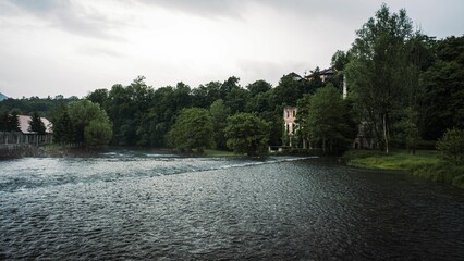 Old abandoned building hidden in the trees next to Krka River, Slovenia