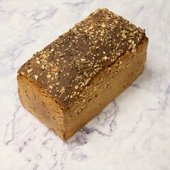 Closeup of a freshly baked loaf of bread on a marble table