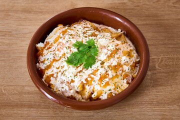 Salad with sour cream and parsley in a clay bowl